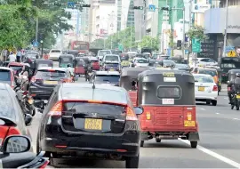  ??  ?? Fighting for road space: Sri Lanka's vehicle population in 2000 was 1,706,382 and it had increased to 6,795,469 in 2016 -- a 298 percent increase