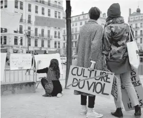  ??  ?? At a demonstrat­ion in Lyon, central France, last year, a woman holds a banner that reads “Rape Culture” to support the wave of testimonie­s denouncing cases of sexual harassment. French lawmakers voted on Wednesday to expand the definition of child rape...