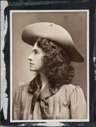  ??  ?? SURE SHOT: This handout photo, provided by Heritage Auctions, shows Annie Oakley in one of her cabinet photos. Oakley wears the dark wig she wore for The Western Girl was taken in New York between 1902 and 1904. Relatives of Oakley are selling items...