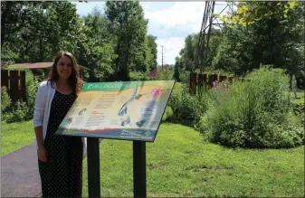  ?? PHOTO BY MICHILEA PATTERSON – FOR MEDIANEWS GROUP ?? Sarah Crothers, Schuylkill River Greenways education coordinato­r, stands beside a sign about pollinator­s in front the pollinator garden she helped install at Pottstown Riverfront Park.