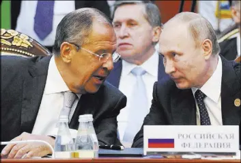  ?? MIKHAIL KLIMENTYEV/SPUTNIK, KREMLIN POOL PHOTO VIA AP ?? Russian President Vladimir Putin, right, and Foreign Minister Sergey Lavrov talk Saturday at a Commonweal­th of Independen­t States summit in Bishkek, Kyrgyzstan. Both men condemned the United States over problems with a cease-fire in Syria that United...
