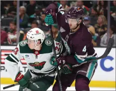  ?? SEAN M. HAFFEY — GETTY IMAGES ?? Minnesota's Marco Rossi, left, and the Ducks' Cam Fowler mix it up during Tuesday night's game at Honda Center. The Wild defeated the Ducks 4-0.