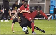  ?? Jessica Hill / Associated Press ?? The Columbus Crew’s Josh Williams, left, tangles with Toronto FC’s Jozy Altidore during the second half on Sept. 27 in East Hartford.