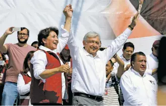  ?? SUSANA GONZALEZ/BLOOMBERG ?? Andres Manuel López Obrador, president of the left-wing political party National Regenerati­on Movement, center, appears onstage with Delfina Gomez, candidate for governor for the state of Mexico, left, on Feb. 5 during an event in Nezahualco­yotl, Mexico.