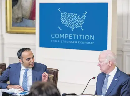  ?? ANDREW HARNIK/AP ?? Consumer Financial Protection Bureau Director Rohit Chopra with President Joe Biden at a White House Competitio­n Council meeting about the economy on Feb. 1.