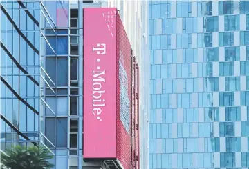  ??  ?? A T-Mobile logo is advertised on a building sign in Los Angeles, California.