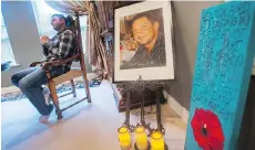  ?? ARLEN REDEKOP ?? Adam Smith sits by a memorial for his brother in December 2014. Robert Tyson Smith was stabbed to death months earlier.