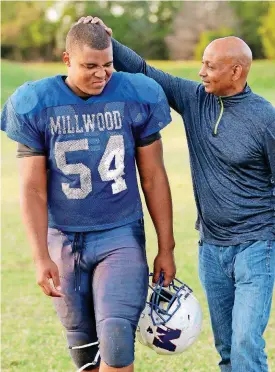  ?? [PHOTO BY DOUG HOKE, THE OKLAHOMAN] ?? Dwayne Antwine, greets his son, Israel Antwine, a defensive tackle at Millwood High School after practice.