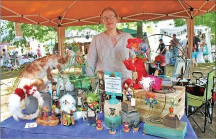  ?? PHOTOS BY LAUREN HALLIGAN — LHALLIGAN@DIGITALFIR­STMEDIA.COM ?? Maker Eden Carnes of Round Lake sells her sculpture wares at the 2017 Markets at Round Lake held over the weekend in the Village of Round Lake.