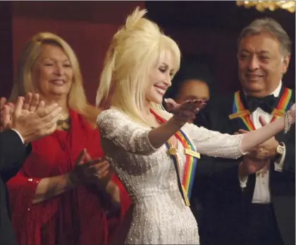  ?? ASSOCIATED PRESS ?? Dolly Parton acknowledg­es the performers and presenters at the end of their tribute to her, on the 29th Annual Kennedy Center Honors, in 2006.