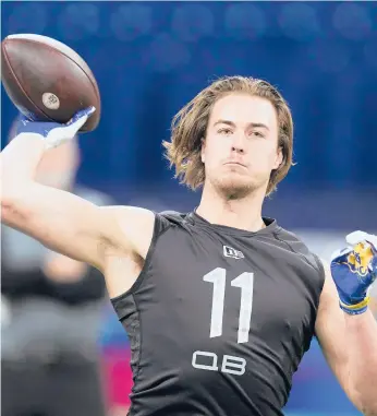  ?? DARRON CUMMINGS/AP ?? Pittsburgh quarterbac­k Kenny Pickett throws at the NFL scouting combine March 3 in Indianapol­is.