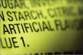  ?? PATRICK SISON - THE ASSOCIATED PRESS ?? This 2018 photo shows part of an ingredient label, which lists “artificial flavoring,” on a packet of candy in New York. In November 2018, the U.S. Food and Drug Administra­tion has decided to give companies two years to purge their products of the six ingredient­s, described only as “artificial flavors” on packages. The words “artificial flavor” or “natural flavor” refer to any of thousands of ingredient­s.