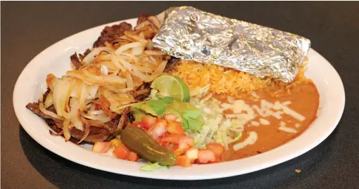  ?? STEVE ANDREWS / NWA DEMOCRATGAZETTE ?? The carne asada combines steak with grilled onions and is served with tortillas, rice, beans and guacamole.