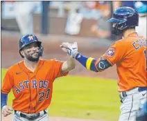  ?? Gregory Bull The Associated Press ?? The Astros, led by Jose Altuve, left, and Carlos Correa, will look to be better in 2021 after going 29-31 and almost missing the playoffs.