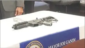  ?? Contribute­d photo / Bridgeport Mayor's Office ?? A ghost gun with a 3D-printed part that was seized last year in Bridgeport.