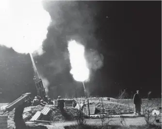  ??  ?? ■ An 88mm gun battery in action against RAF night bombers over the Reich.