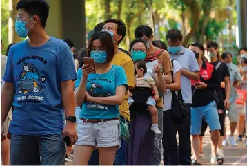  ?? Associated Press ?? ■ People queue up to vote Sunday in Hong Kong in an unofficial primary for pro-democracy candidates ahead of legislativ­e elections in September. More than 200,000 Hong Kongers voted in an unofficial Hong Kong primary that will help the pro-democracy camp decide which candidates to field in legislativ­e elections in September. The turnout exceeded organizers' estimates that some 170,000 people would turn up to vote over the weekend.