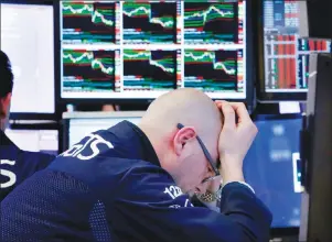  ?? AP PHOTO ?? Specialist Mario Picone works at his post on the floor of the New York Stock Exchange, Friday, April 6, 2018. Stocks are falling again as trade tensions heat up between the U.S. and China.