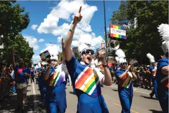  ?? ASHLEE REZIN/ SUN- TIMES ?? Lakeside Pride Music Ensemble members march in last year’s Chicago Pride Parade.