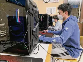  ?? Michael Walsh/Hearst Connecticu­t Media ?? David Do and Ryan Jiang, members of the Hall High School esports team, play League of Legends after school in January of 2022.