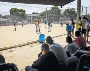  ??  ?? Vecinos ven el partido en la cancha del Cinco y seis.