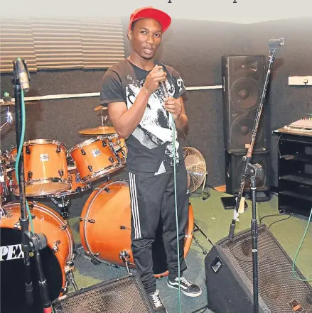  ??  ?? Charleston rapper Gerald Nyakura — also known as G Breezy — in the recording studio.