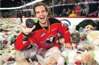  ?? DARREN MAKOWICHUK ?? Calgary’s Kaden Elder celebrates amid a flurry of Teddy Bears in Sunday’s victory over the Kamloops Blazers. The annual Brick Teddy Bear Toss saw a record 29,635 stuffed toys tossed on the ice.