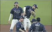  ?? JAE C. HONG — THE ASSOCIATED PRESS ?? The Tampa Bay Rays’ Willy Adames, back left, and Brandon Lowe celebrate after the Rays defeated the New York Yankees 2-1in Game 5of an AL Division Series on Friday in San Diego.