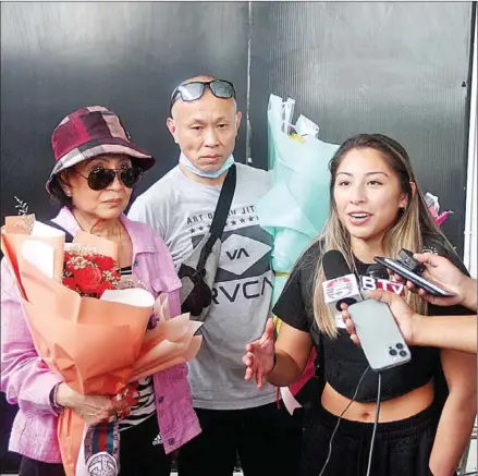  ?? CHHORN NORN ?? Cambodian Ju-Jitsu star Jessa Khan (right) speaks to reporters after arriving at Phnom Penh Internatio­nal Airport before her trip to compete in the SEA Games in Vietnam this month.