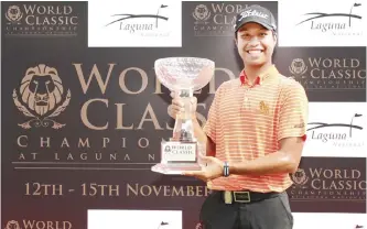  ??  ?? SINGAPORE: In this handout photograph taken and received from the Asian Tour, Danthai Boonma of Thailand posing with the trophy after winning the World Classic Championsh­ip at Laguna National Golf and Country Club in Singapore. — AFP