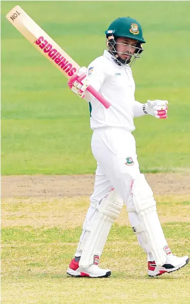  ?? Agence France-presse ?? Bangladesh’s Mushfiqur Rahim raises his bat after scoring a double century during third day of their Test match against Zimbabwe at the Sher-e-bangla National Cricket Stadium in Dhaka on Monday.