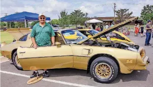  ??  ?? Bret Ellard, of Shawnee, stands with his 1978 “Gold Special Edition” Pontiac Firebird Trans Am on Tuesday at Moore’s Celebratio­n in the Heartland.