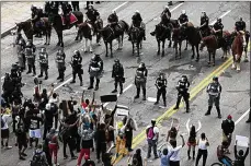  ?? JOSHUA A. BICKEL / COLUMBUS DISPATCH ?? Racial injustice protesters stand in the middle of Broad Street in downtown Columbus on May 30, 2020.