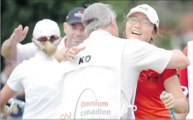  ?? — GETTY IMAGES ?? Lydia Ko gets a hug from her caddy Brian Alexander after her three-shot victory.