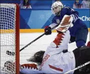  ?? MINNEAPOLI­S STAR TRIBUNE ?? Jocelyne Lamoureux-Davidson of the U.S. scores past Canada goalie Shannon Szabados during the shootout in Wednesday’s gold medal game.