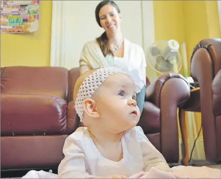  ?? NANCY MACPHEE/JOURNAL PIONEER ?? Six-month-old Avelyn Cormier enjoys some tummy time as her mom, Jessica, keeps a watchful eye on her daughter. Jessica is one of a handful of Summerside area mothers who have signed on to become Bosom Buddies. Family Place is getting ready to launch...