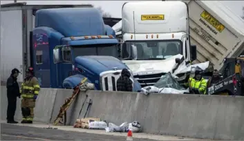  ?? Yffy Yossifor/Star-Telegram via AP ?? Emergency personnel clean up after a massive pileup on Interstate 35 on Feb. 11, 2021, near downtown Fort Worth, Texas. The crash, which killed six and injured dozens, involved 130 vehicles. Federal officials said the company responsibl­e for the interstate failed to address the deteriorat­ing road conditions.
