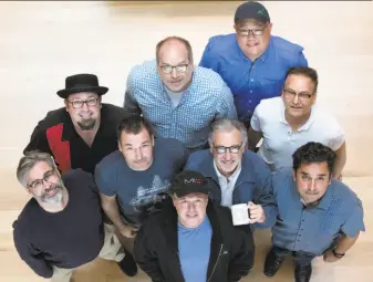  ?? Santiago Mejia / Special to The Chronicle ?? “Iron Giant” vets, clockwise from left: Kevin O’Brien, Adam Burke, Tony Fucile, Peter Sohn, Jeffrey Lynch, Andrew Jimenez, John Walker (holding cup), Brad Bird and Mark Andrews.