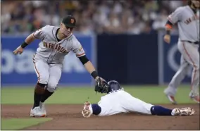  ?? ORLANDO RAMIREZ - THE ASSOCIATED PRESS ?? San Diego Padres’ Greg Garcia, center, is caught stealing as San Francisco Giants second baseman Joe Panik, left, applies the tag during the sixth inning of a baseball game Saturday, July 27, 2019, in San Diego.