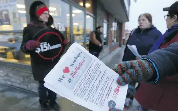  ?? CLIFFORD SKARSTEDT / POSTMEDIA NEWS FILES ?? Protesters in Peterborou­gh hand out informatio­n pamphlets at a Tim Hortons.