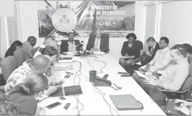  ??  ?? Minister of Natural Resources Raphael Trotman (right at head of table) speaking at the press conference (Department of Public Informatio­n photo)