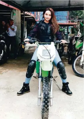  ??  ?? Azira Shafinaz Ramlan on an off-road motorcycle. She says her ultimate motocross goal is to perform extreme stunts.