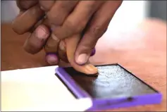  ??  ?? An electoral commission official marks with ink the thumb of a voter after casting his ballot during the presidenti­al election at a polling centre in Analakely, Antananari­vo, Madagascar. — Reuters photo