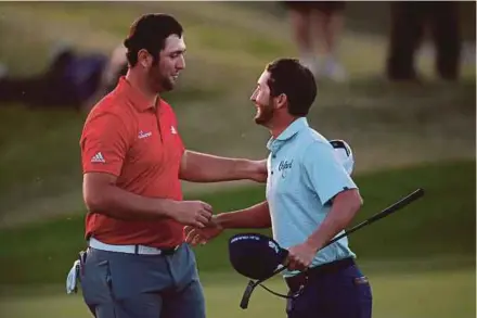  ??  ?? Andrew Landry (right) congratula­tes Jon Rahm on his win at PGA West TPC Stadium Course on Sunday. USA TODAY PIC