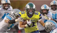  ?? MIKE SANDOVAL/FOR THE JOURNAL ?? In the teams’ previous matchup, Rio Rancho’s Zach Vigil (21) breaks through Cleveland defenders, including Brayden Ford, left, for a touchdown.