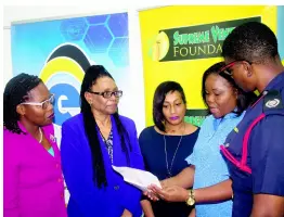  ?? PETRE WILLIAMS-RAYNOR ?? Christine Staple-Ebanks (second right), founder of the Nathan Ebanks Family Expo and Fair, in discussion with Dr Winsome Townsend (second left), project manager for the Adaptation Programme and Financing Mechanism of the Pilot Programme for Climate Resilience, and other partners.