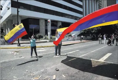  ?? Wil Riera ?? The Associated Press Demonstrat­ors wave Venezuelan national flags Tuesday during a protest against President Nicolas Maduro in Caracas.