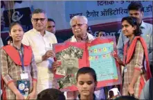  ?? PTI ?? Students present a birthday card to Chief Minister Manohar Lal Khattar as he distribute­d tablets to them in Rohtak on Thursday