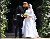  ??  ?? Wedding bliss... the Royal couple kiss outside the chapel