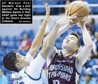  ?? JOEY MENDOZA ?? UP Maroon Paul Desiderio fires a shot against NU Bulldog Matthew Aquino in their UAAP game last night at the Smart Araneta Coliseum.